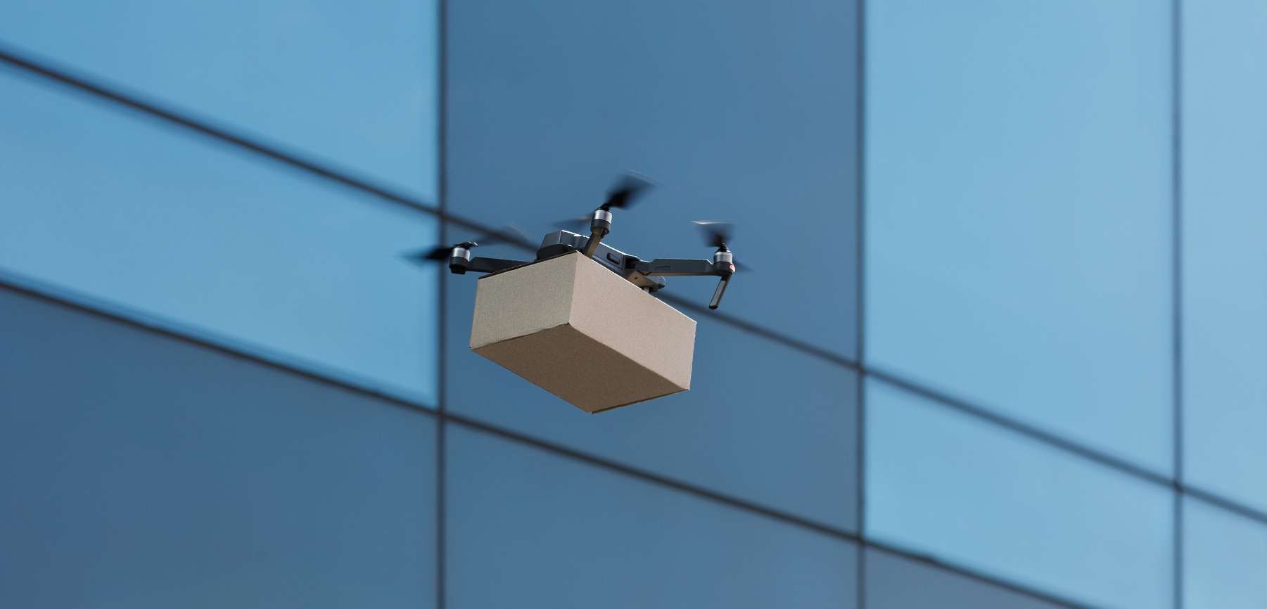 Quadrocopter delivering parcel by air in the city